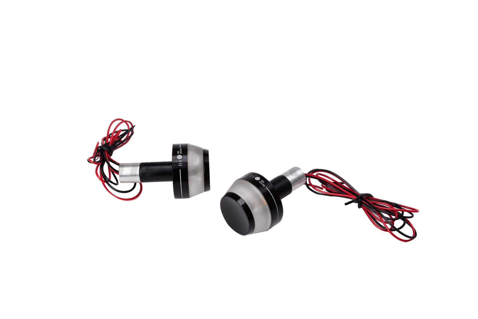 A pair of black motorcycle handlebar end turn signals with red wiring against a white background.