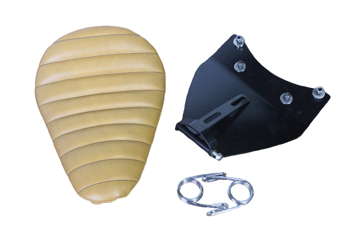 Brown leather saddle pad, black leathercraft tool, and metal clip on a wooden surface