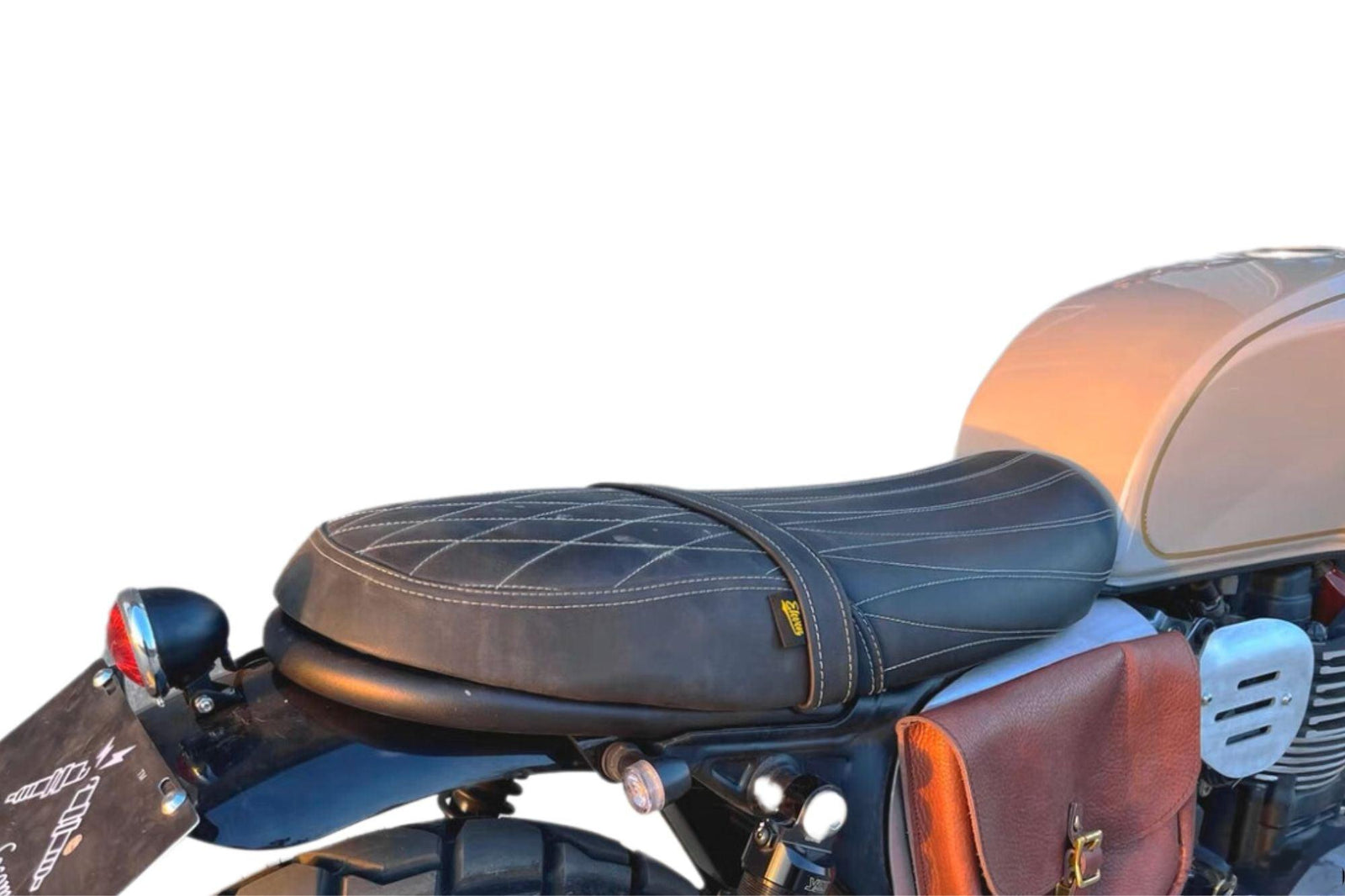 Custom motorcycle saddle kit including a black saddle, buckle, taillight, and plate solder mounted on a motorcycle BRIXTON 1200