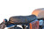 Custom motorcycle saddle kit including a black saddle, buckle, taillight, and plate solder mounted on a motorcycle BRIXTON 1200