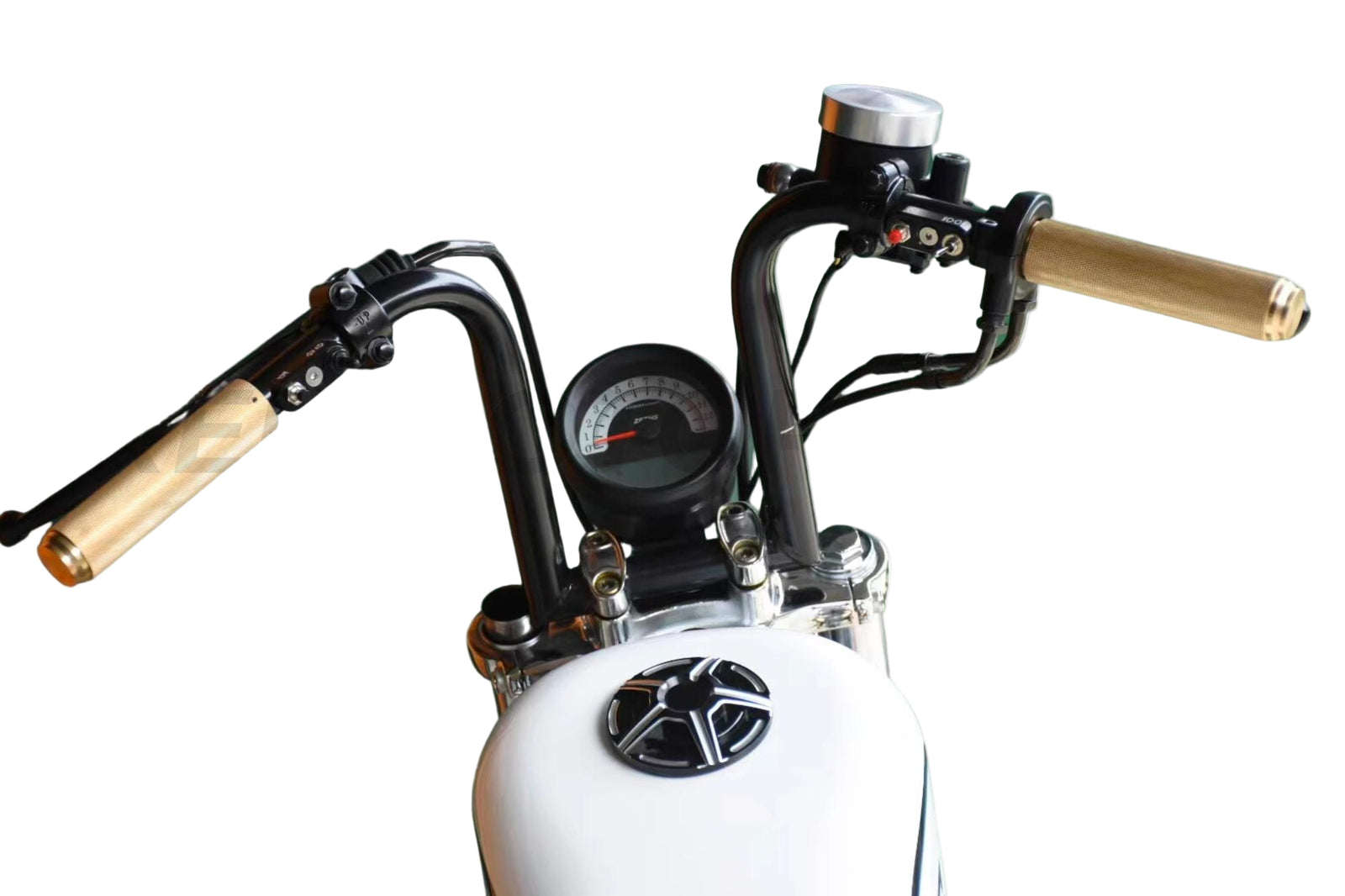 Gold brass non-slip grips installed on a motorcycle handlebar, with a speedometer and decorative star visible in the foreground.